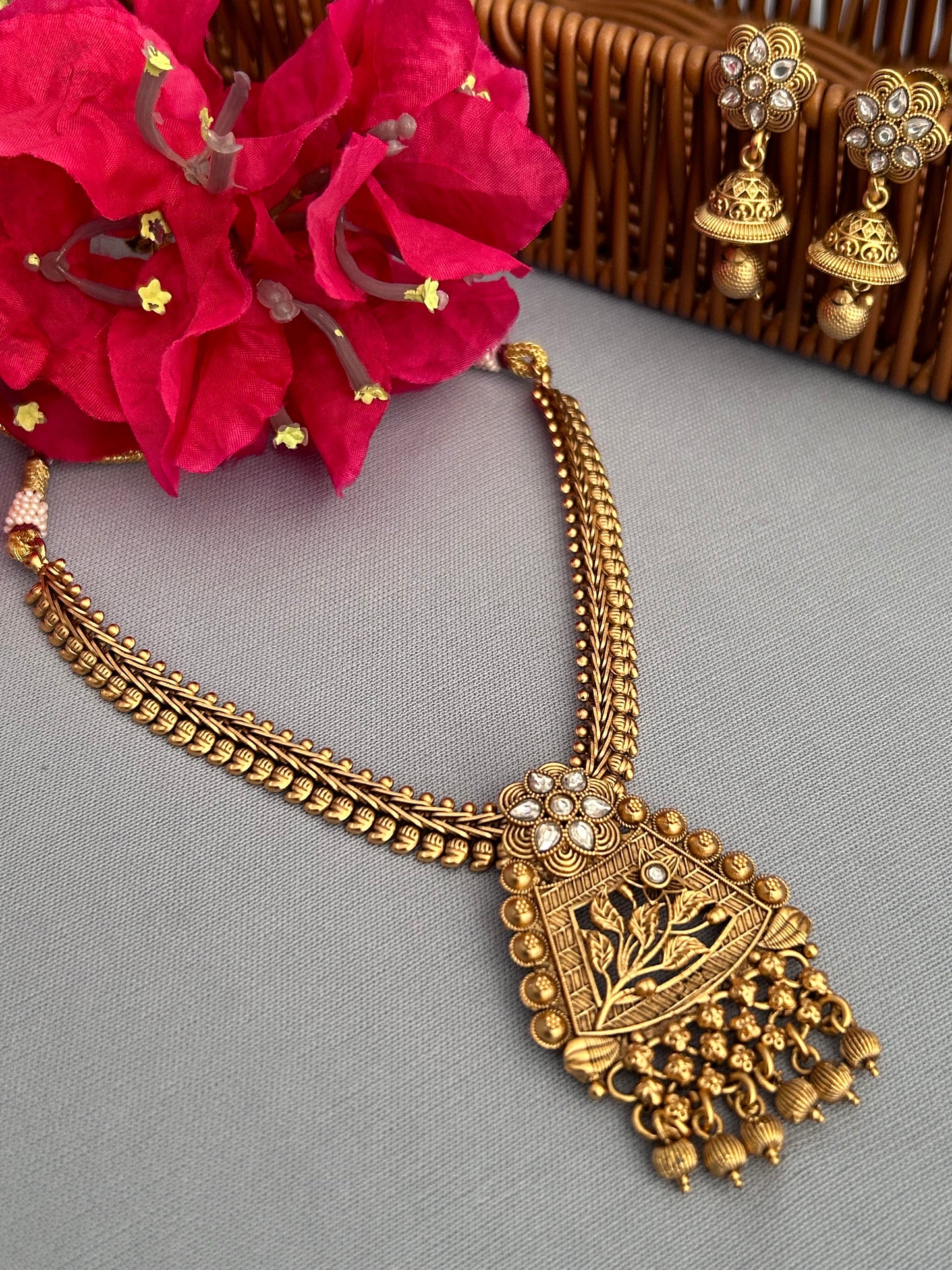 Antique Gold Necklace with Diamond Studded Locket and Intricate Jhumkas