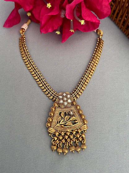 Antique Gold Necklace with Diamond Studded Locket and Intricate Jhumkas